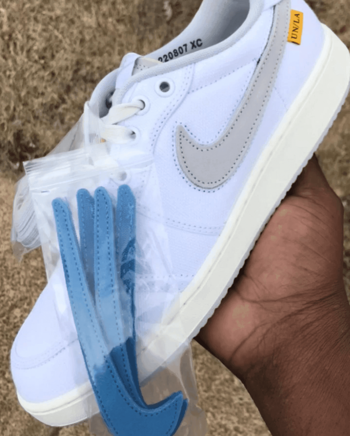 A person holding a shoe

Description automatically generated with low confidence